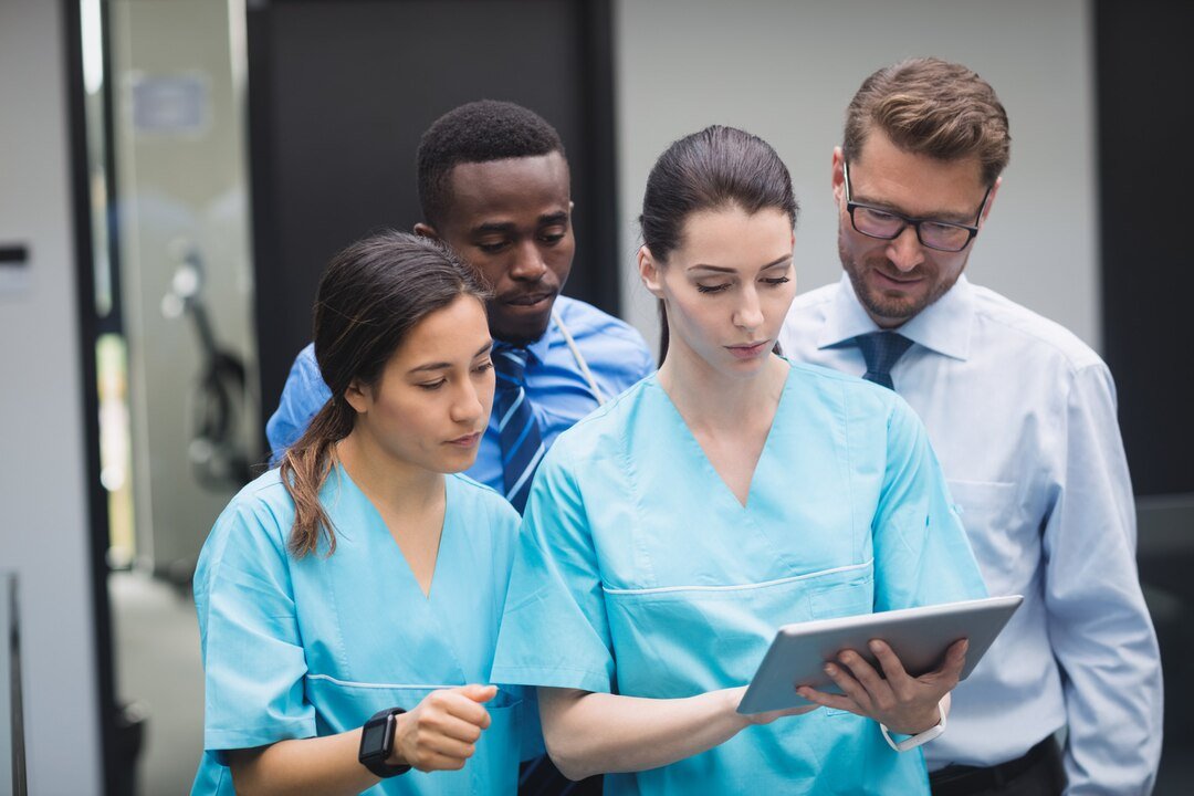 medical team discussion on tablet